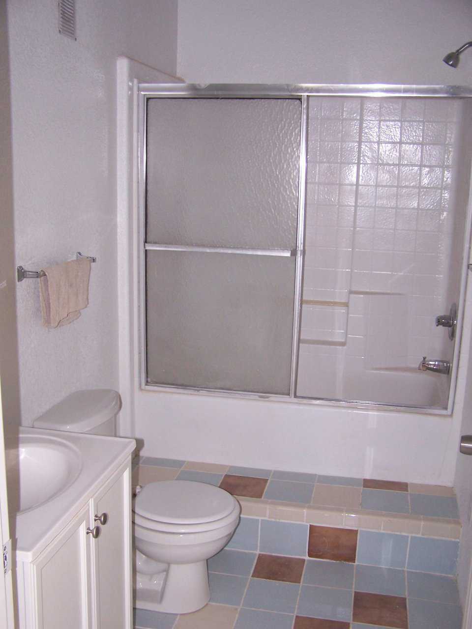 Guest bathroom — It includes a tub with an enclosed shower.