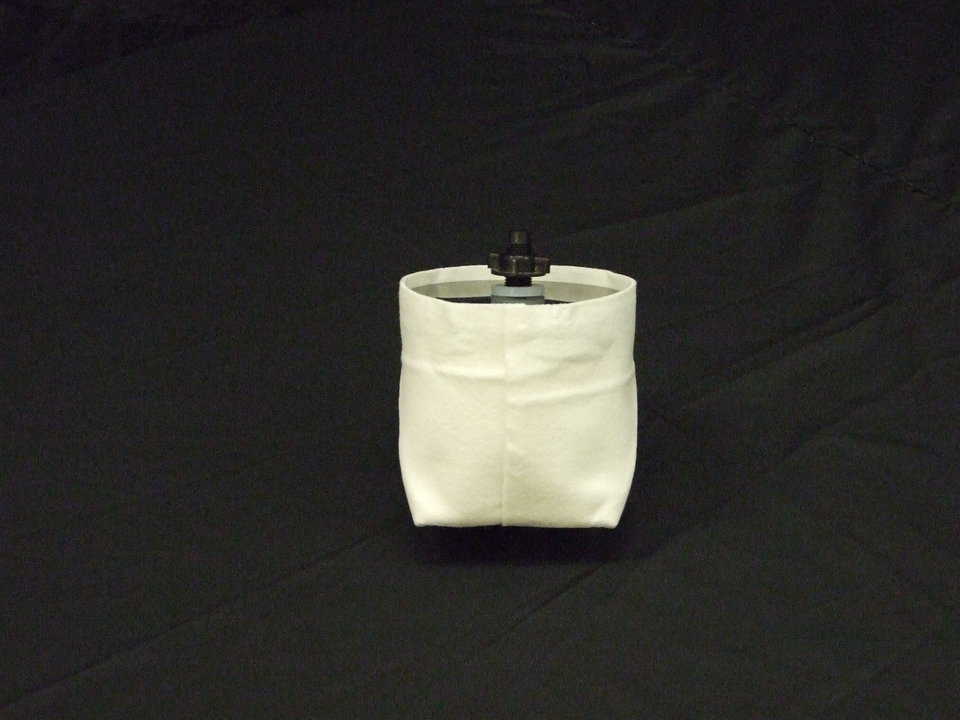 Step 8 — Remove filter from packaging. (Note: There is a cloth outer filter that prevents larger debris from clogging the ceramic filter. This outer filter can be washed as needed as you would a regular cloth.) Wash the ceramic filter with cold water and a clean cloth. If it does get clogged, it may be cleaned with a 3m Scotch-Brite pad.