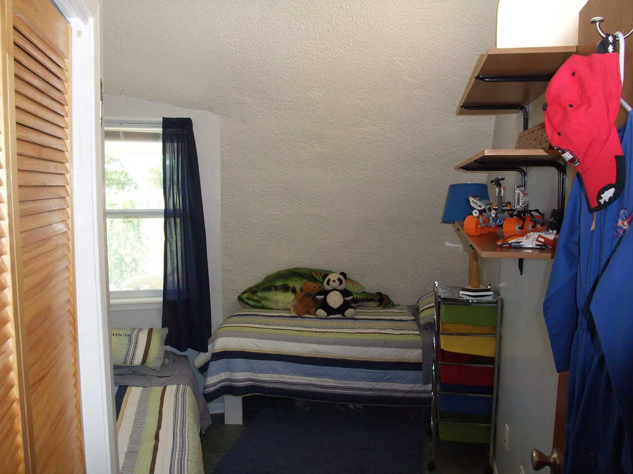 Boys’ bedroom — It includes beds and shelves for toys, tools and books.
