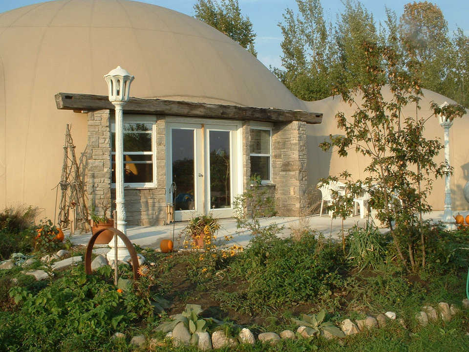 Monolithic Dome Dream Home — Rebecca and Sunny Cushnie of Southampton Ontario, Canada enjoy these two interconnected domes. The larger dome includes the main living/dining area, a kitchen, laundry room and two bedrooms. The smaller come encompasses the master suite.