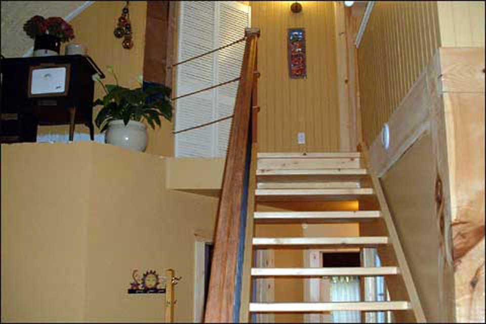 Going Up — A staircase leads to the upper bedrooms and loft.