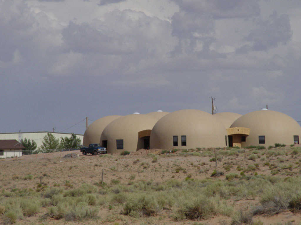 Rentals — These 32-foot-diameter Monolithic Domes are residential rentals built for Tolchii’ Kooh teachers and citizens at Taloni Lake, Arizona.