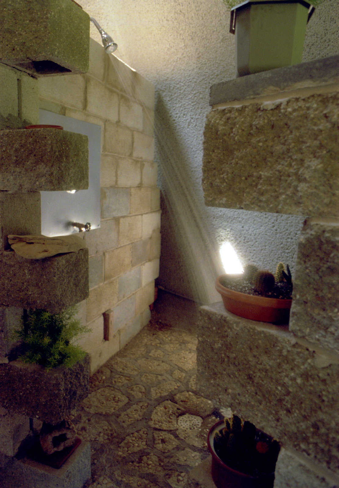 Luxurious bath — The custom shower uses the dome wall, natural rock and concrete block.