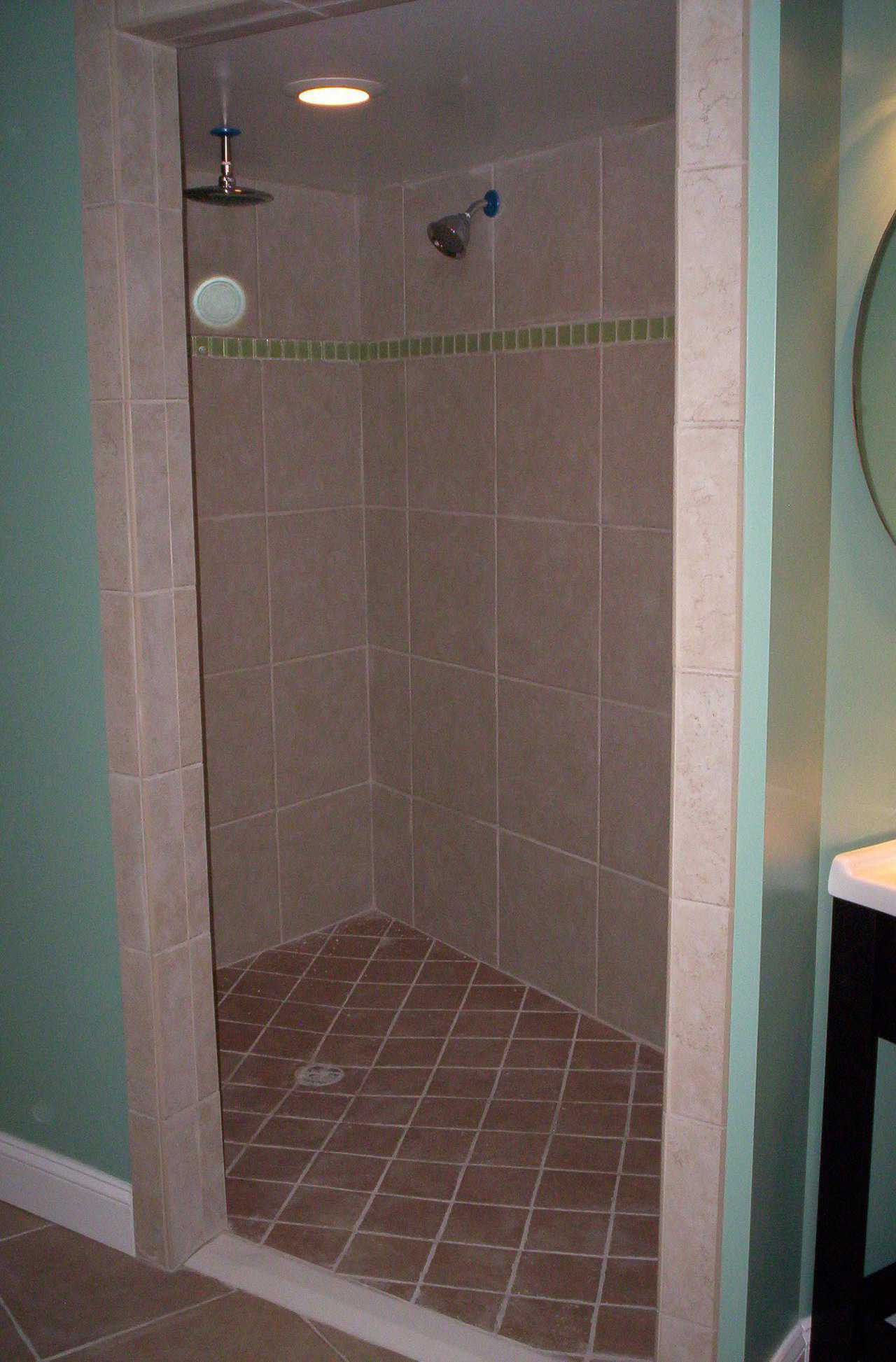 Roomy and Easily Maintained — Walk-in shower sports tile in bold, contrasting colors and space for a shower chair.