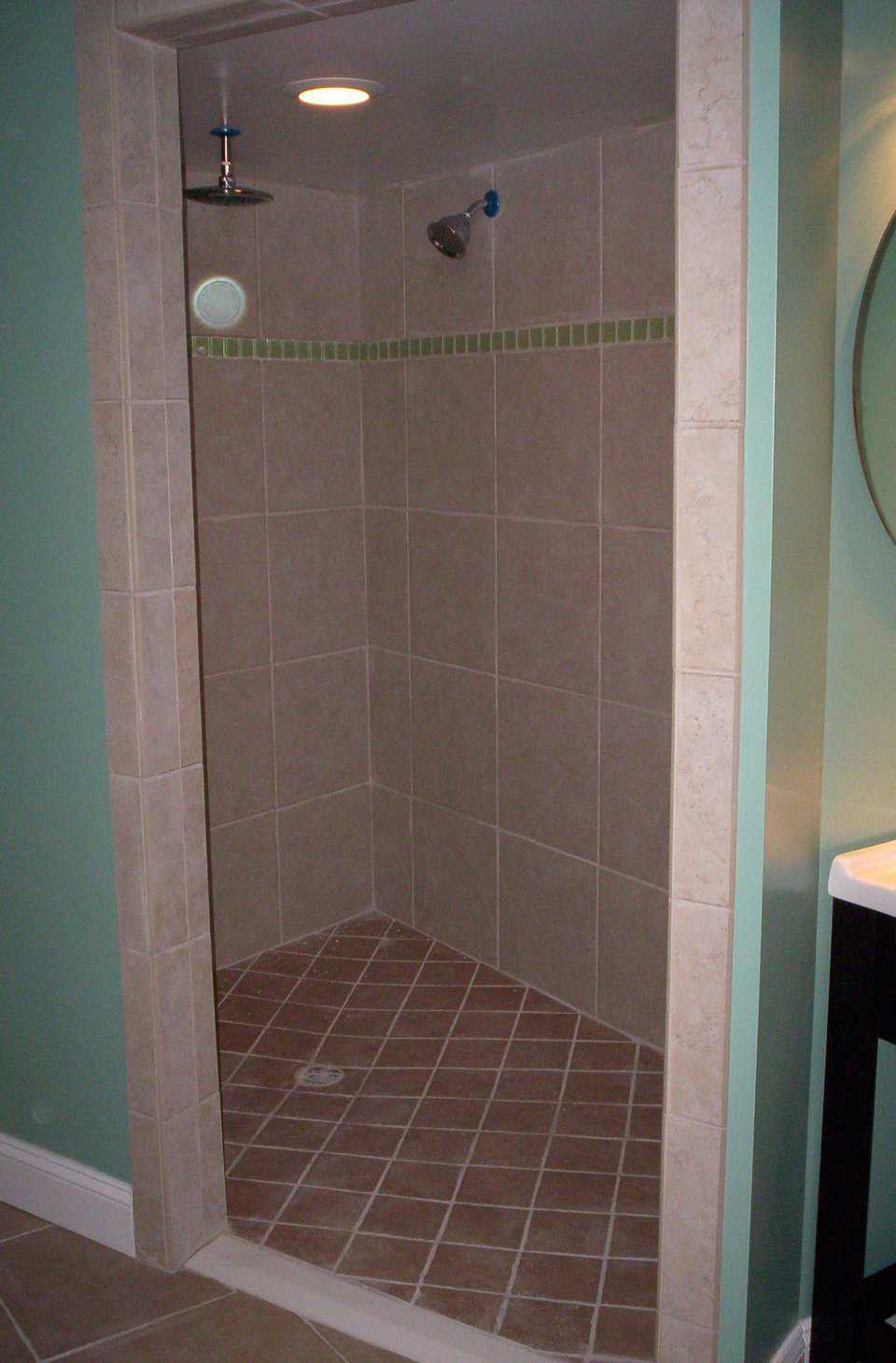 Roomy and Easily Maintained — Walk-in shower sports tile in bold, contrasting colors and space for a shower chair.