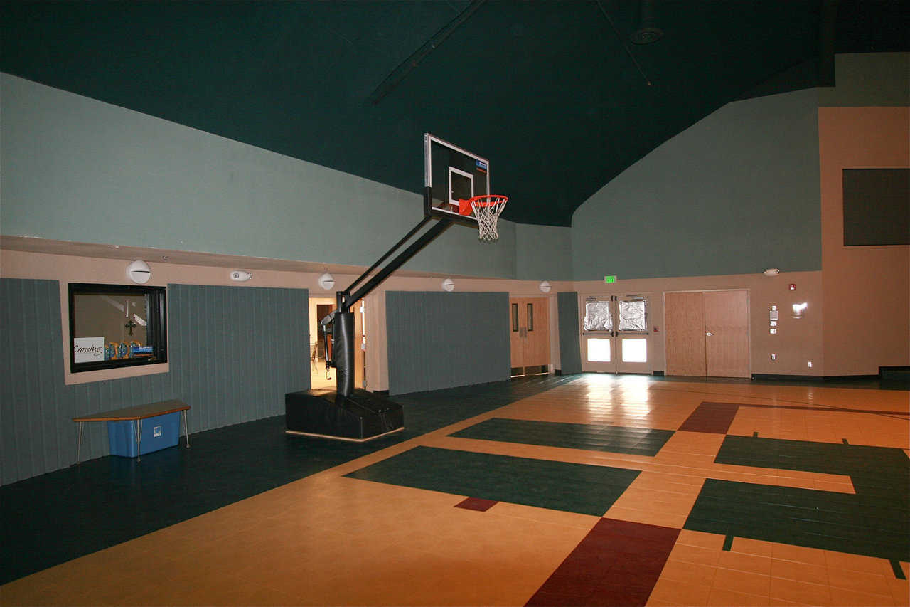 Safety first! — The basketball court features versapanel walls that protect players, help with acoustics and that can be used as room dividers.