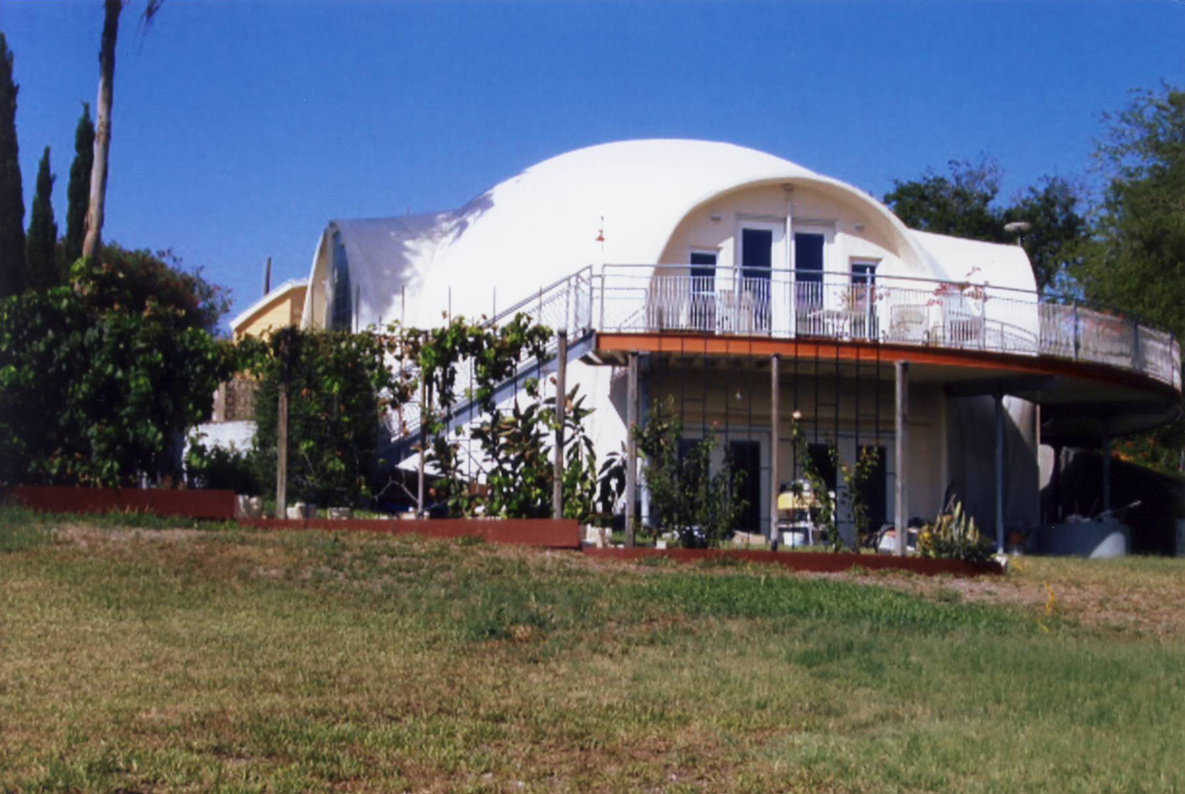 Graceful Curves — This beautiful Monolithic Dome home was also designed and constructed with an integrated stemwall