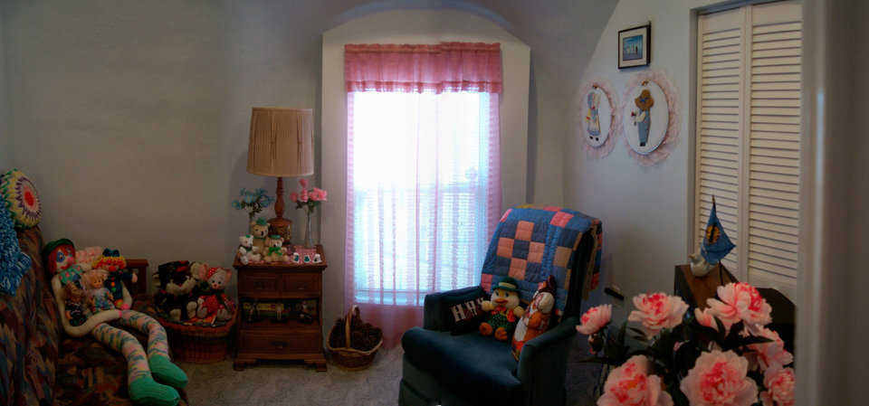 Guest bedroom — It comfortably accommodates and displays Shirley’s large collection of stuffed character dolls.
