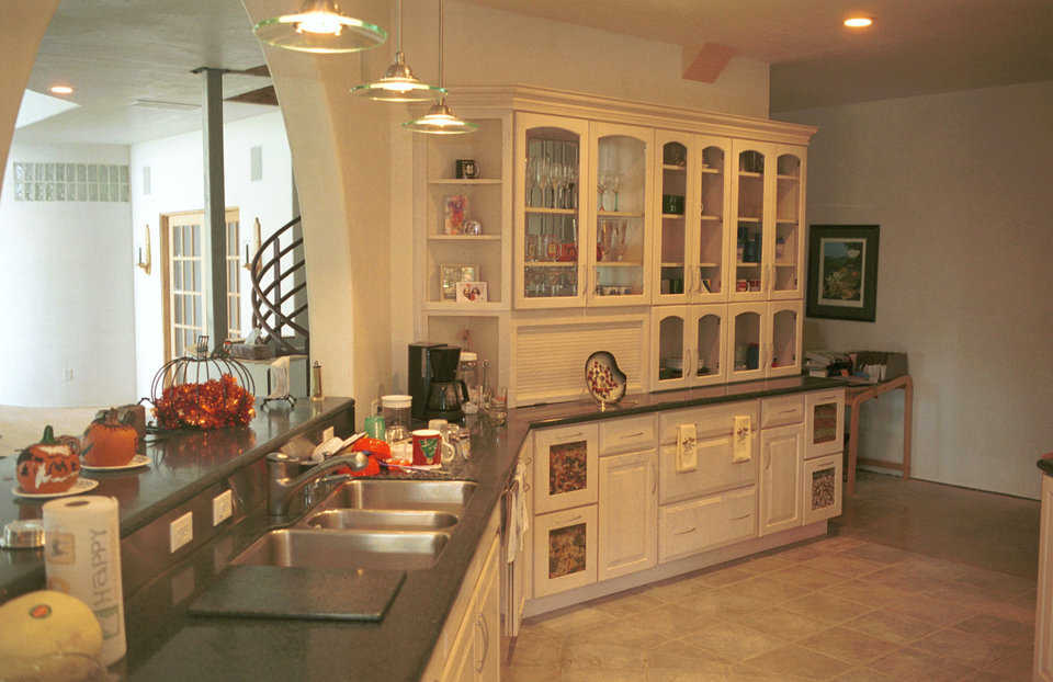 Spacious kitchen — Excess storage makes this kitchen extremely functional. The archway overlooks the central living area.