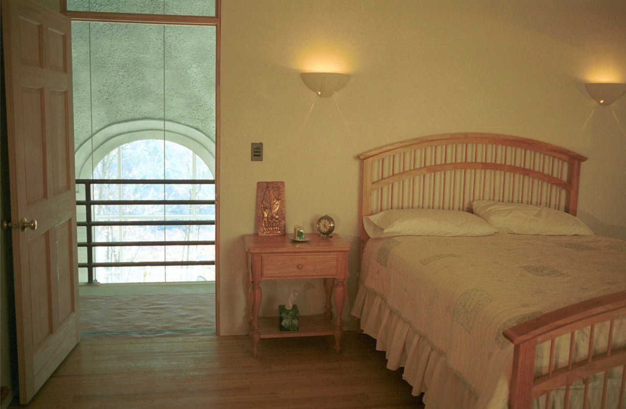 Guest bedroom — It’s entered off the balcony that overlooks the central living area.