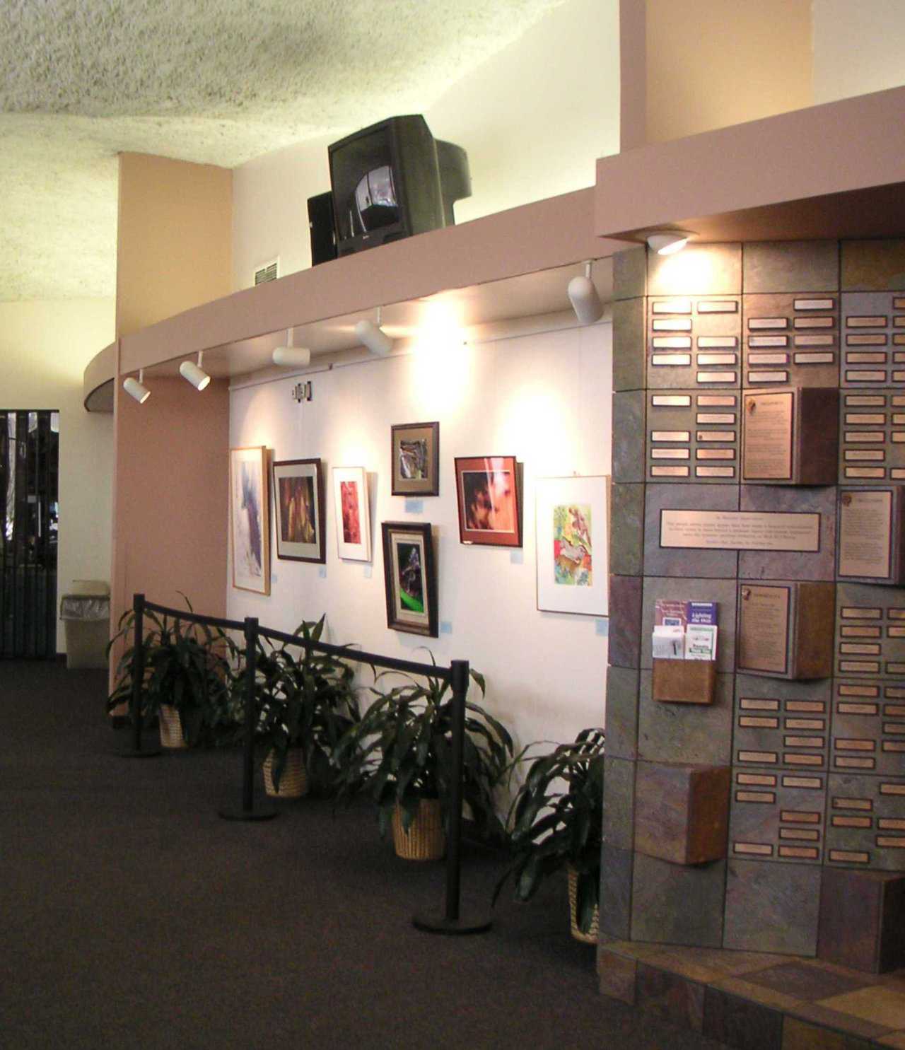 Lobby — Soft lighting, framed art work and plants greet visitors.