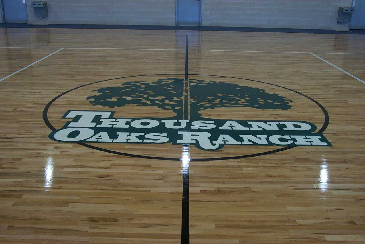 Logo — The full-size basketball court carries the center’s logo.