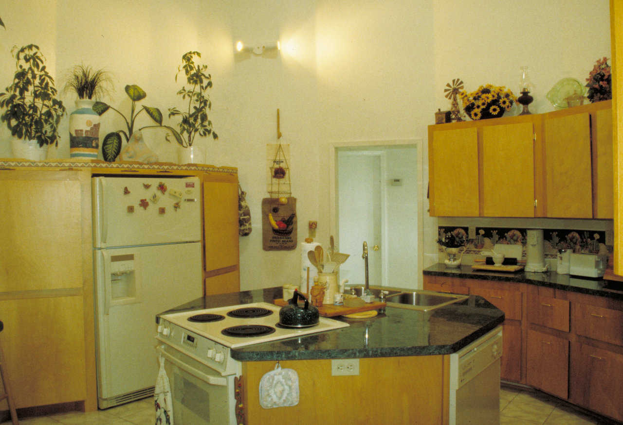 Kitchen — It’s in the center or heart of the house. All other areas radiate from it. The hexagon work center is extremely functional.