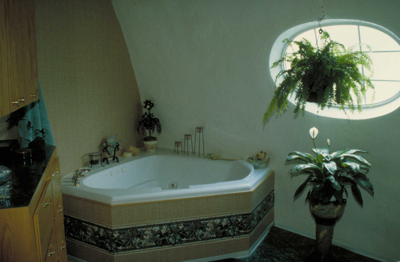 Whirlpool tub — A surrounding shelf makes the tub fit against the dome’s rounded walls.