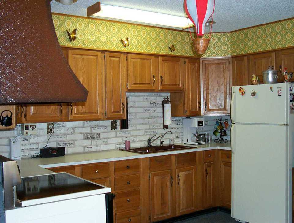 Kitchen — Wood cabinets outline the spacious kitchen.