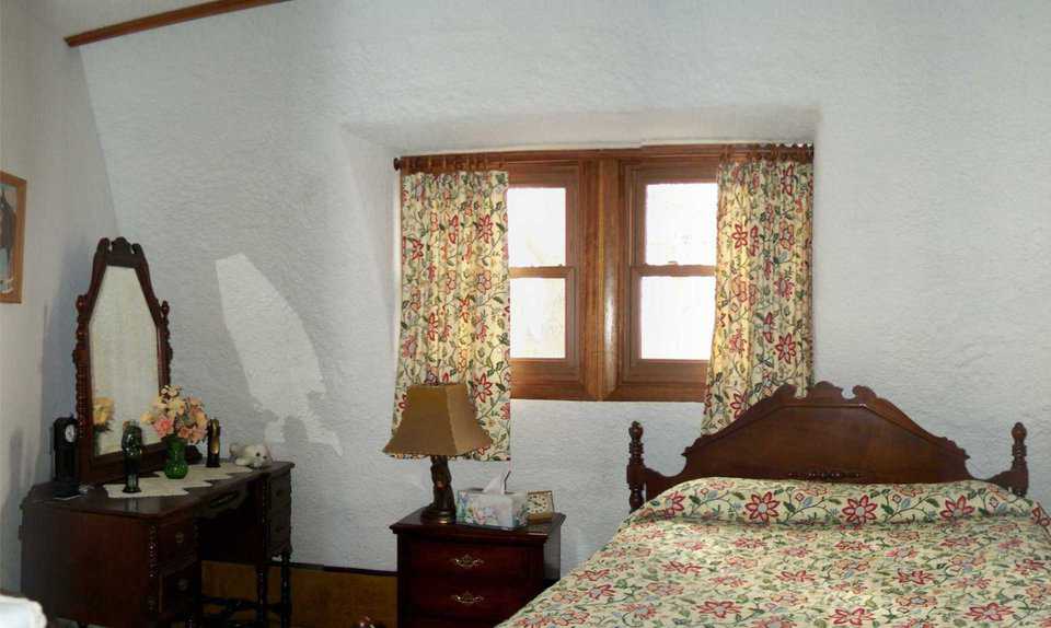 Guest bedroom — The Stewarts furnished their beautiful, large, guest bedroom with family antiques.