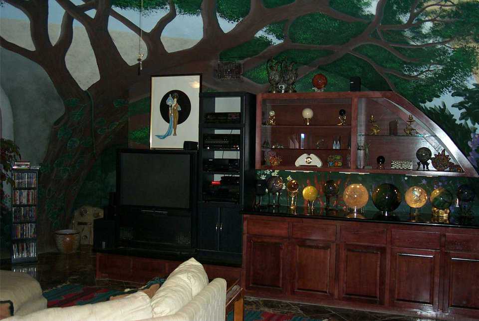 An indoor forest — A canopy of plump, lifelike tree branches embraces the main living area.