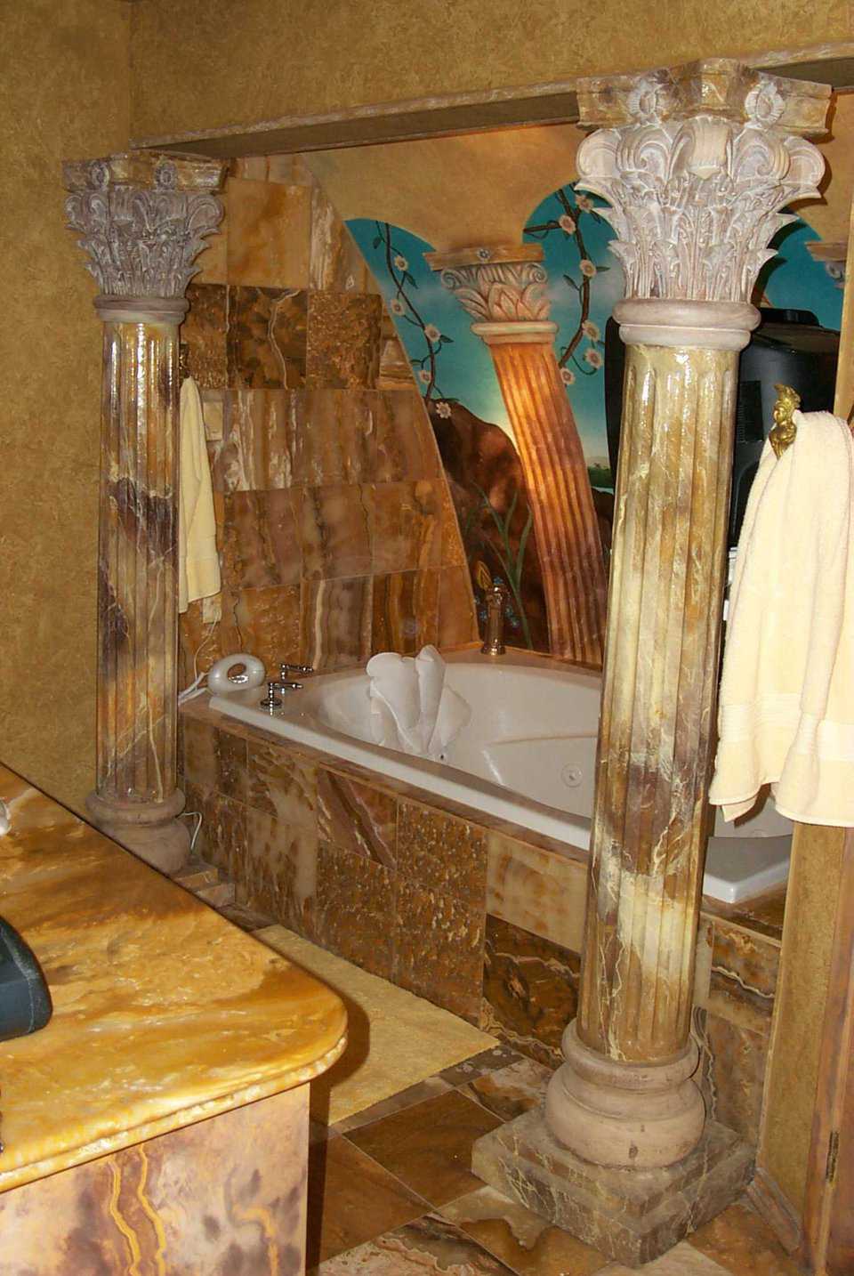 Luxurious Bathroom — Fixtures in this master bath match the authentic marble floor. Via an elevated television, you can view seascapes and relaxation videos while bathing.
