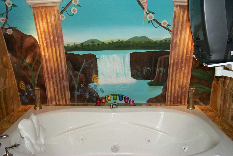Oversize Tub — It’s an invitation to relax that’s hard to resist. Soft lighting provided by scented candles and a waterfall add to the serenity.