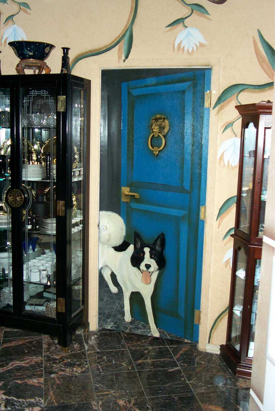Hidden Tail — This pantry door is painted to appear open, but is actually closed. Look closely for the doorknob hidden in the tail of Glenn’s pet Akita.