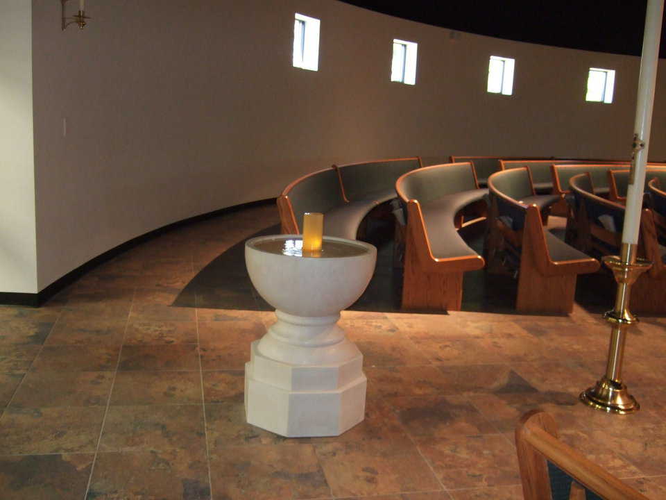 Baptismal font — Father Monaghan found a local artisan to design and craft a font whose lines and shape complement that of the dome.