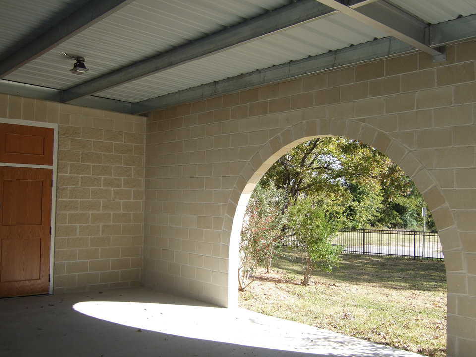 Arched openings — The connecting wall between the new dome-church and the old church has three arched entrances that open onto the covered patio/walkway.