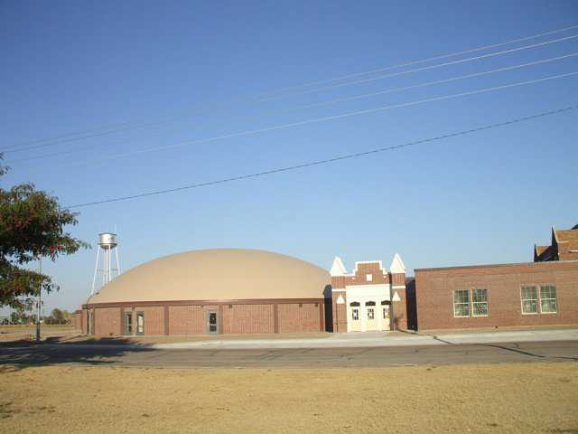 In designing a new Monolithic Dome to adjoin an existing, rectangular school building, Architect Gray used bricks whose color matched that of the bricks in the old building.