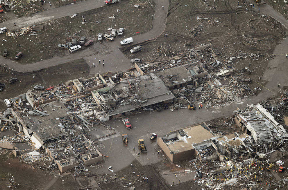 An aerial photo showing damage to Plaza Towers Elementary School after it was hit by a massive tornado in Moore, on May 20, 2013. Rescue workers and a helicopter can be seen at lower right.