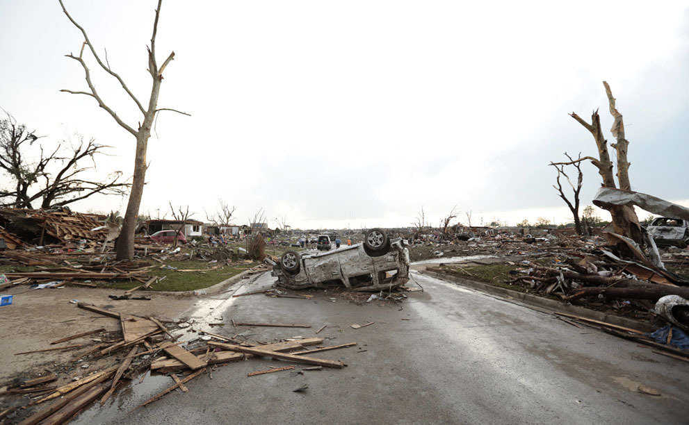 A vehicle lies upside down in the road after a powerful tornado ripped through the area on May 20, 2013 in Moore, Oklahoma.