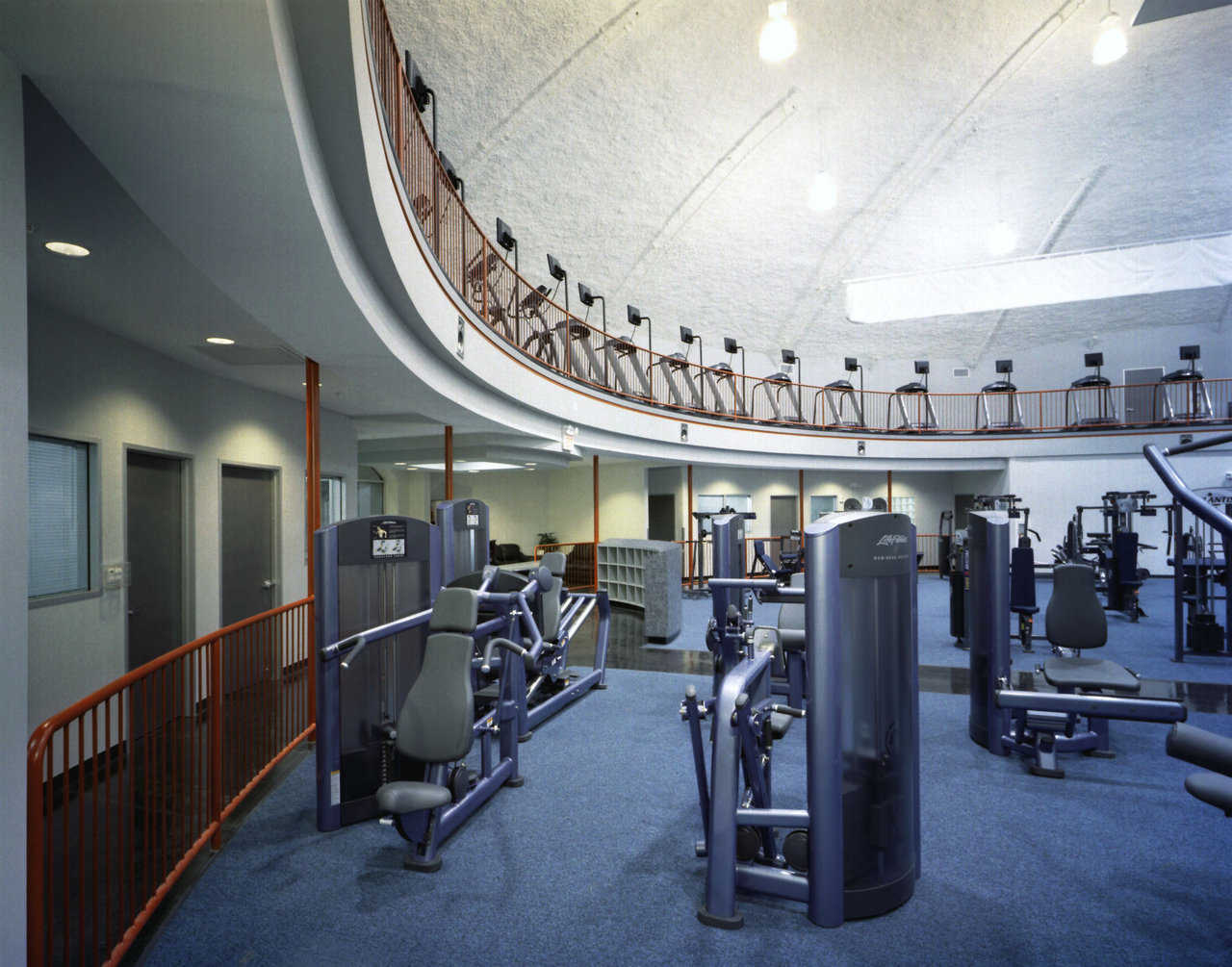 The upper level features a large number of cardio machines overlooking the lower level which provides strength training equipment, locker rooms, sauna and childcare.