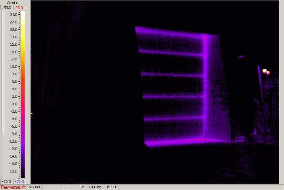 This picture shows the same building through a thermographic camera at the same 25 degrees below zero. Note the Monolithic Dome is black. This is a heated shop. There is no heat loss through the Dome shell. The door (insulated) is leaking heat especially at the cracks between the sections and along the edges.