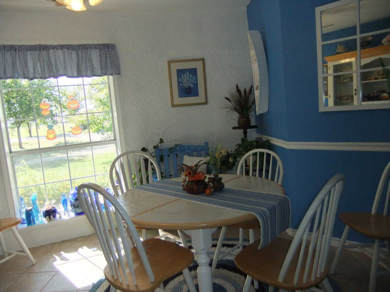 Family Dining Area — One wall sports a large window so sunshine pours through while another is painted a happy blue.