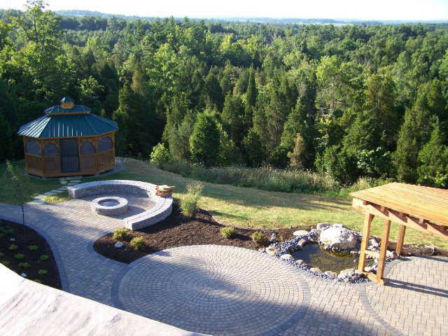 Continuity — The circular shapes of the pavers subtly reinforce the shape of the house