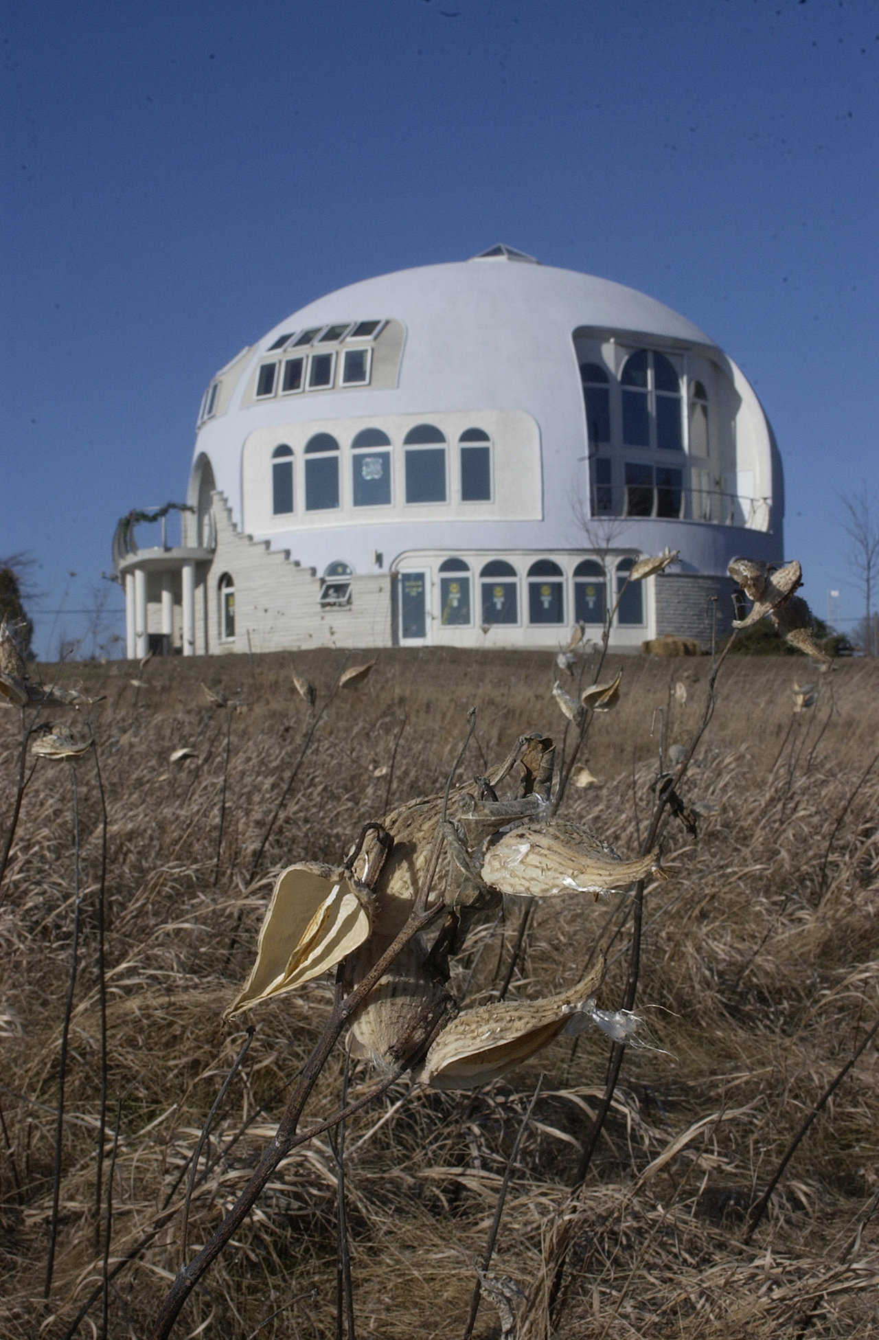 The Disappearing Dome — This a Monolithic Dome with a diameter of 55 feet and three stories. The Disappearing Dome overlooks Lake Michigan.