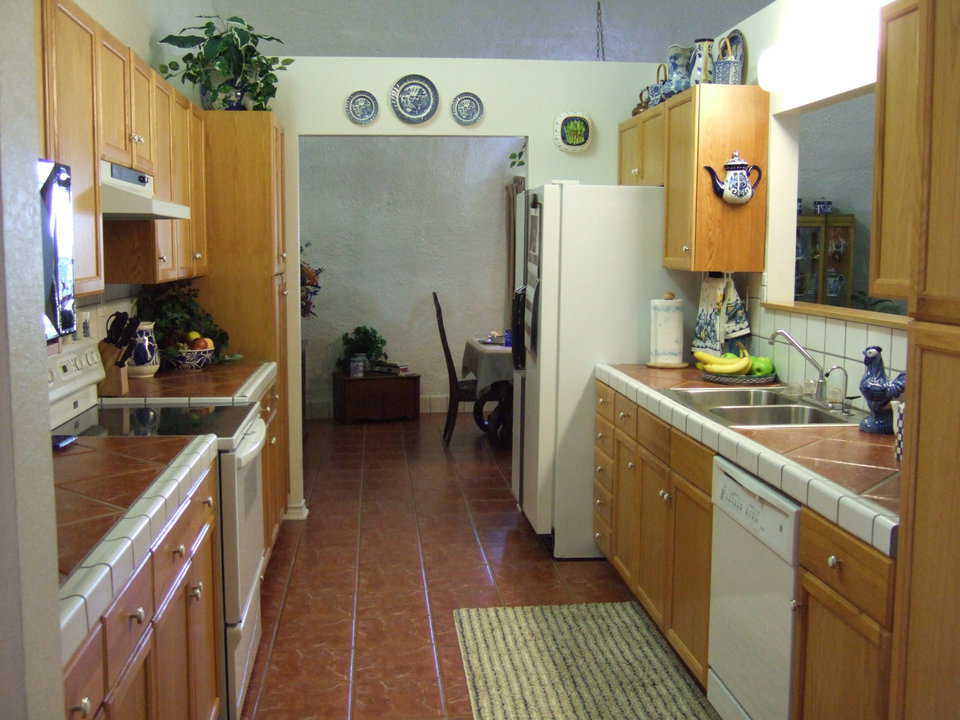 Kitchen — An efficient work area and generous storage dominate this kitchen.