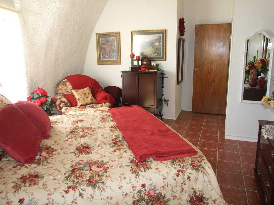 Bedroom 1 — Creamy whites and rosy pinks adorn this bedroom.