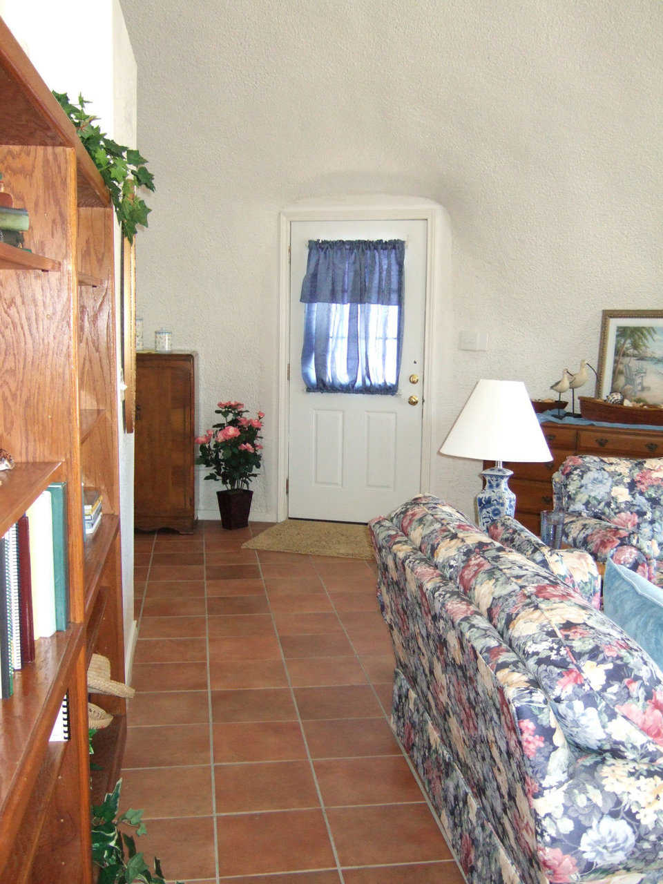 An inviting entry  — A curtained front doorway welcomes visitors.