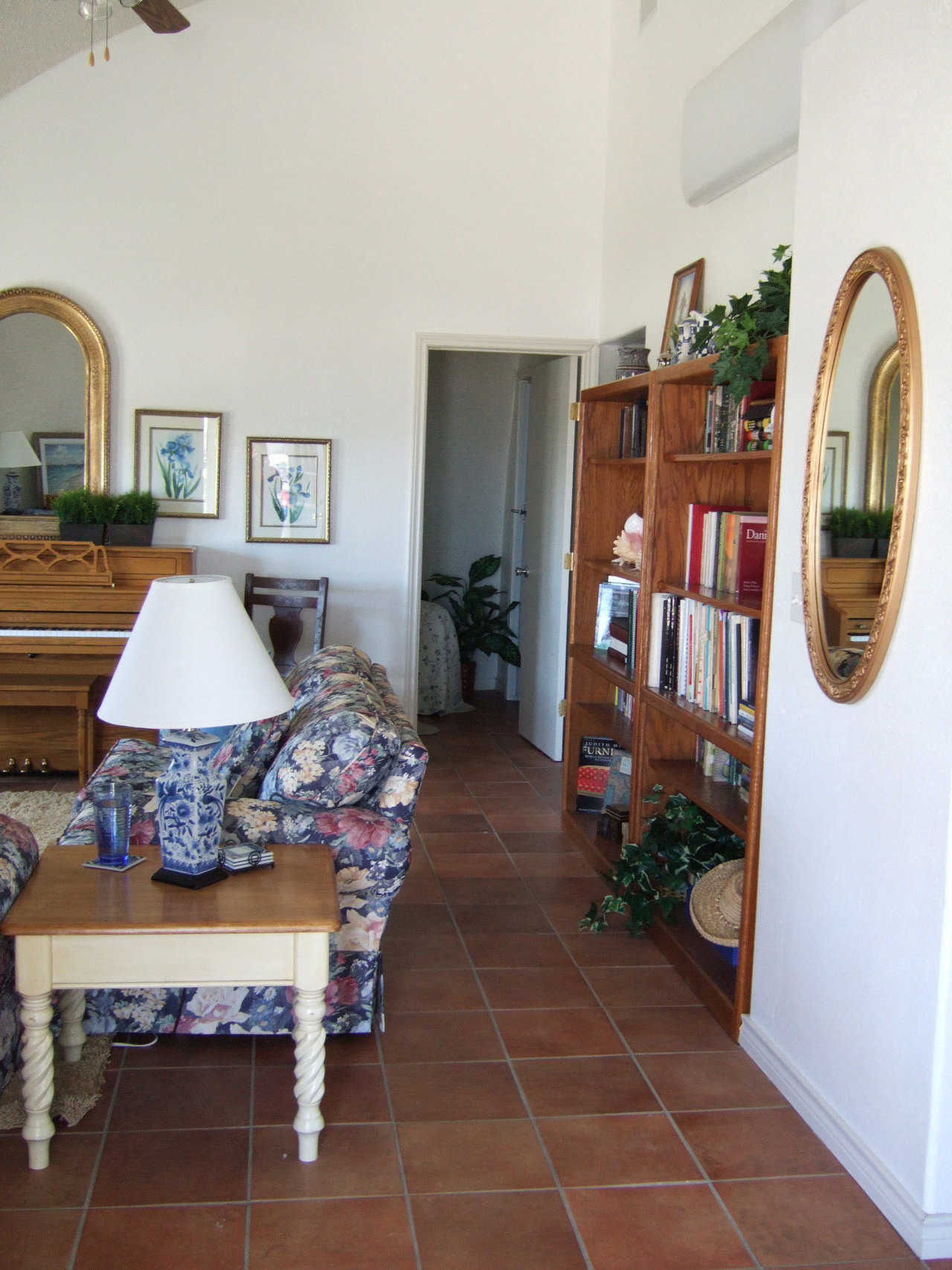 By design — Bookshelves lining the wall create an attractive display and a pathway to a bedroom.