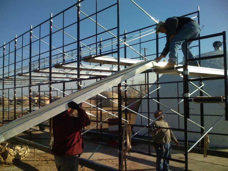 Setting up planks — Here we are putting up the 10’ wide scaffold planks that we will use to add on another level of scaffolding.