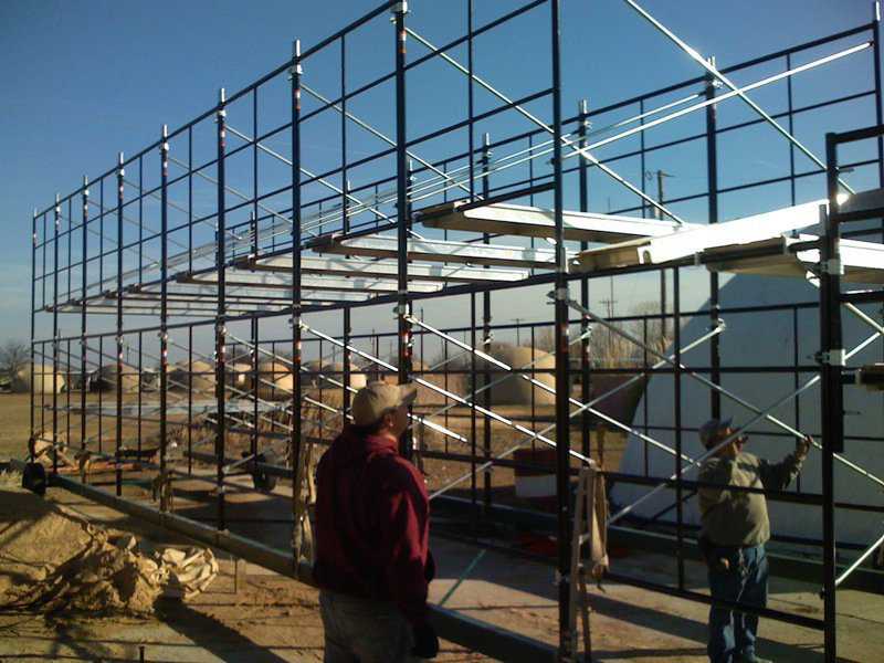 Setting up planks — Here we are putting up the 10’ wide scaffold planks that we will use to add on another level of scaffolding.