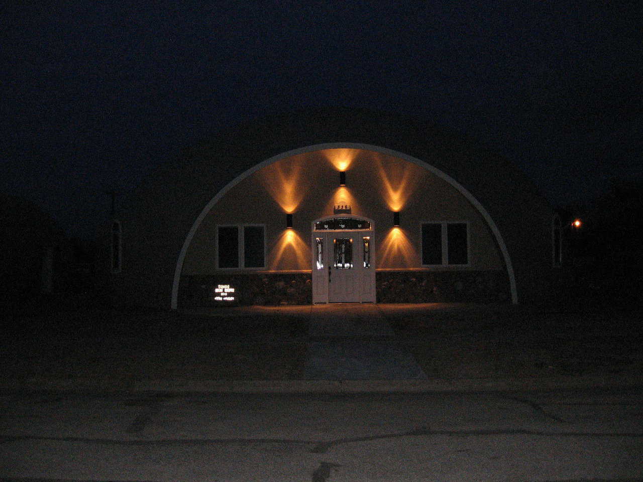 A welcoming light in the darkness! — Despite the hour or the weather, the Mudds feel safe and secure in their Monolithic Dome on the Prairie.