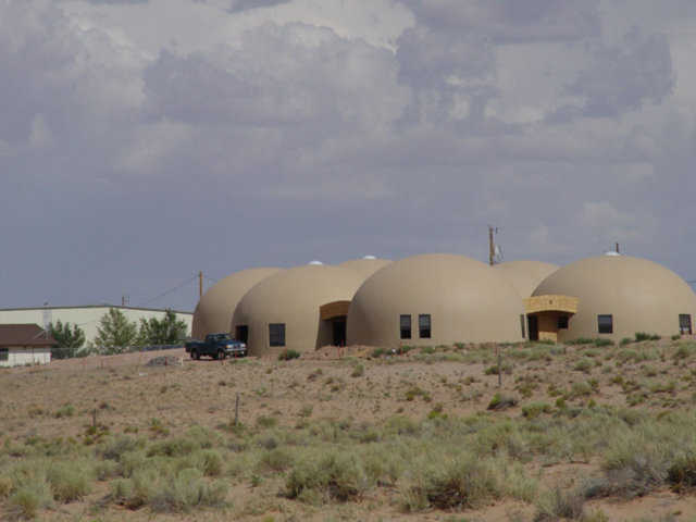 Rentals — These 32-foot-diameter Monolithic Domes are residential rentals built for Tolchii’ Kooh teachers and citizens at Taloni Lake, Arizona.