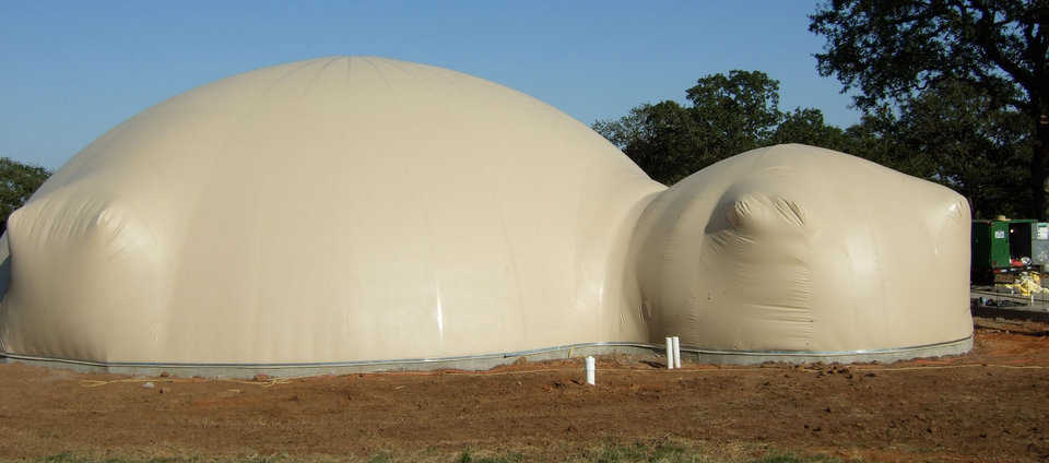 Airform Inflated — This multi-dome Airform has just been inflated. The augments will now be formed with wood and forced into position making a nice, wrinkle-free door way. The saddle connection between the two domes will also be strapped down into place.