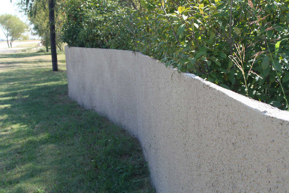 Monolithic Fences — Monolithic uses single side forms and our shotcrete equipment to make great fences. This concrete fence is only 2" thick.