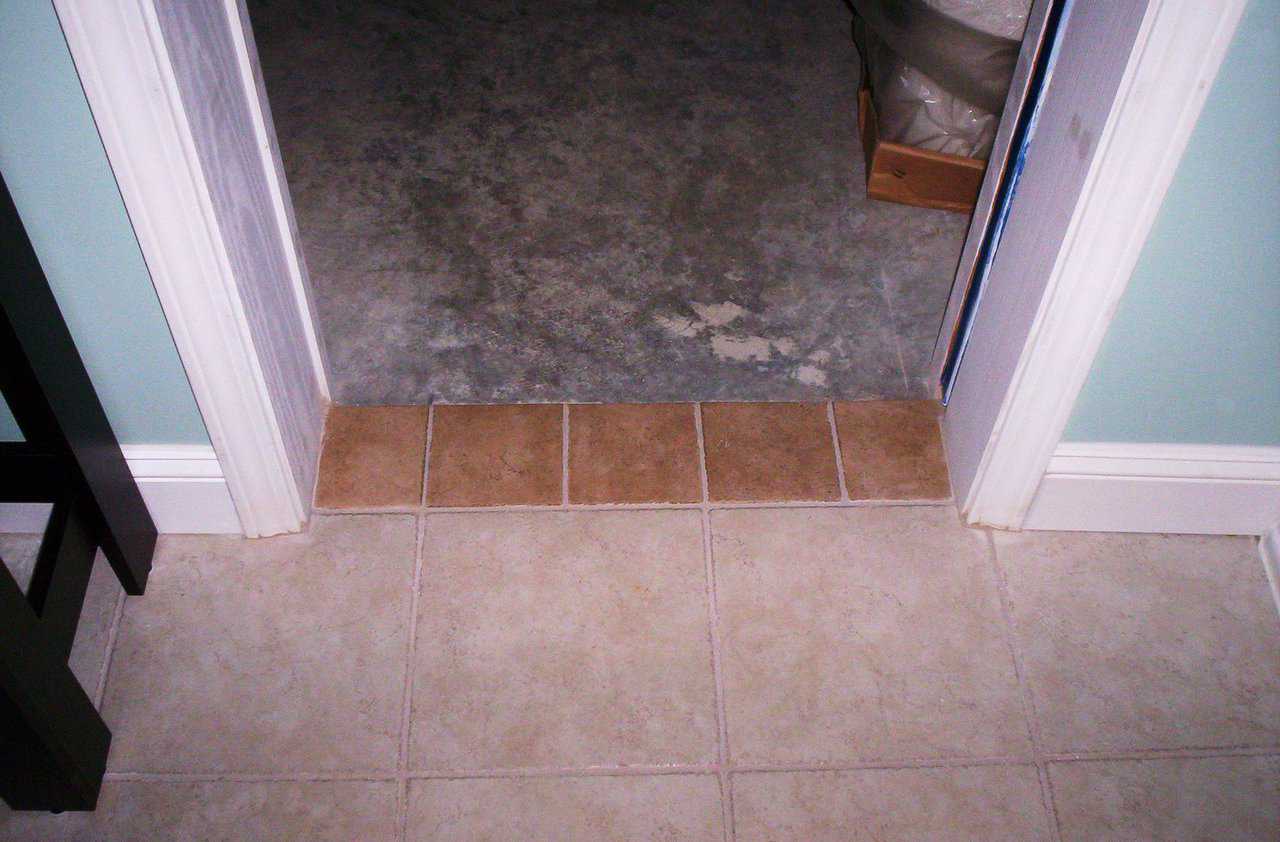 Obvious Floor Changes — Chance of tripping is decreased with contrasting size and color of floor border tile in doorways.