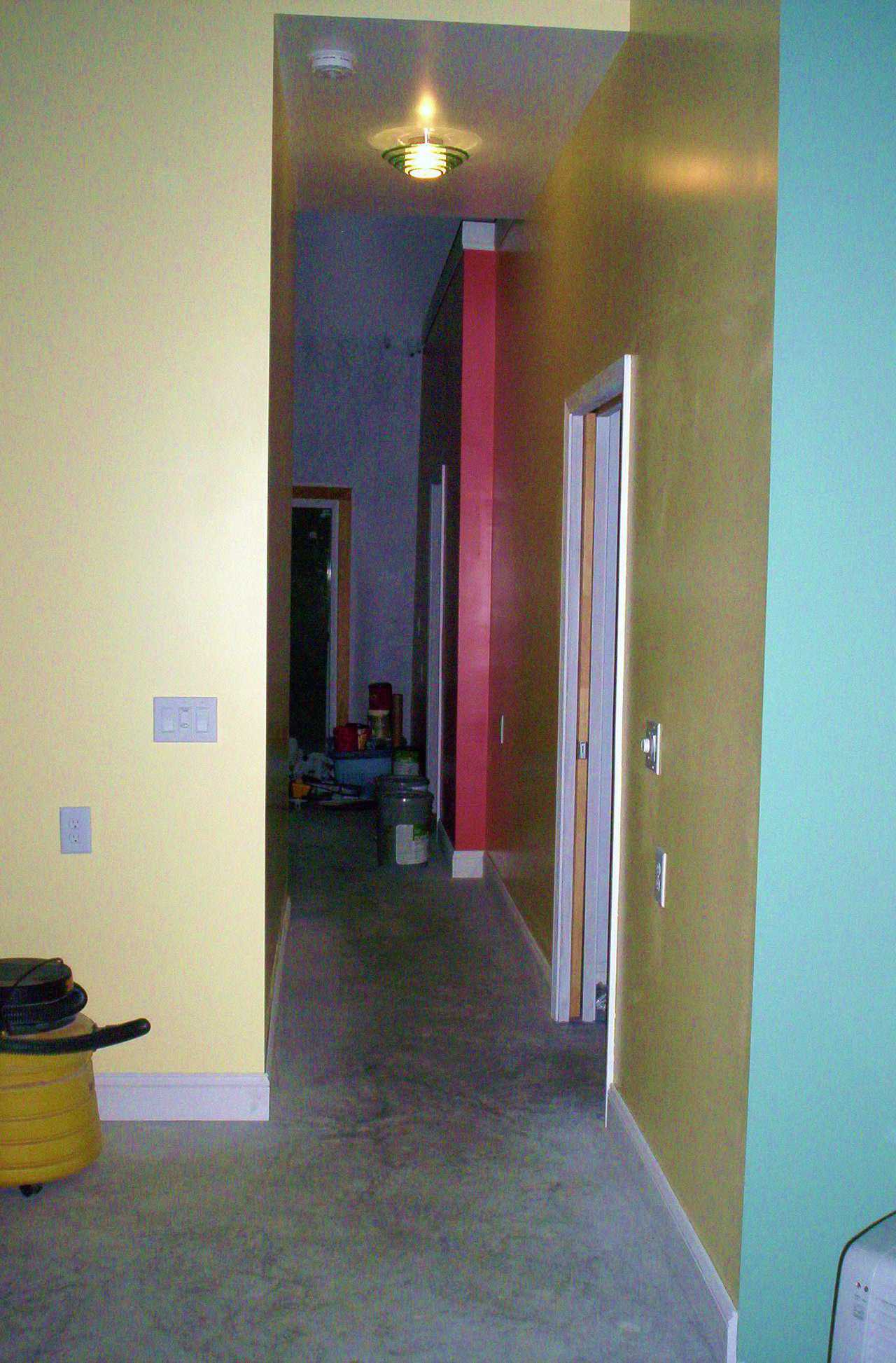 Wide Hallway — Bold colors break up spaces and identify corners and outcroppings.  A 36" wide hallway allows safe passage for persons with a cane, walker or wheelchair. (Ceilings are 9’ tall, which makes the hall width appear less than 36".)