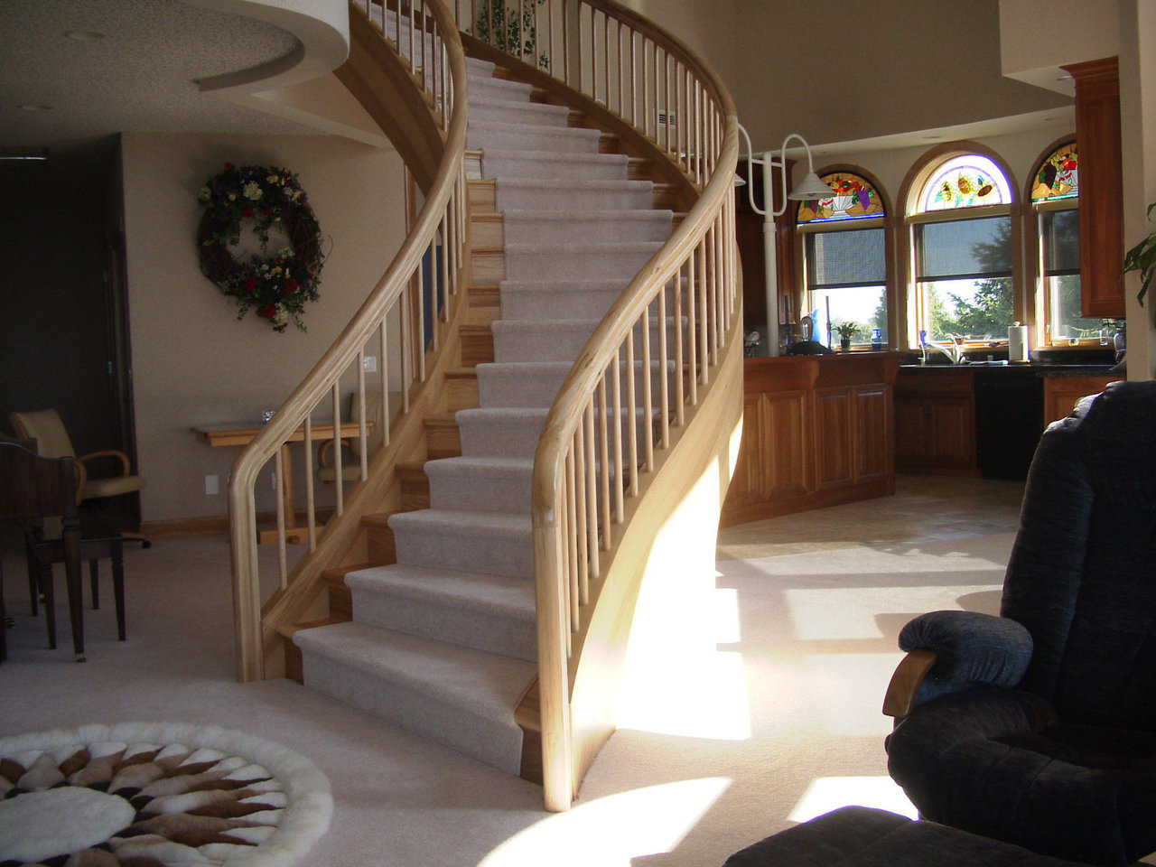 The Disappearing Dome in Manitowac, Wisconsin — Fashioned using natural hickory, a sweeping stairway leads from the main floor to the third level of this Monolithic Dome home with 4000 square feet of living space.