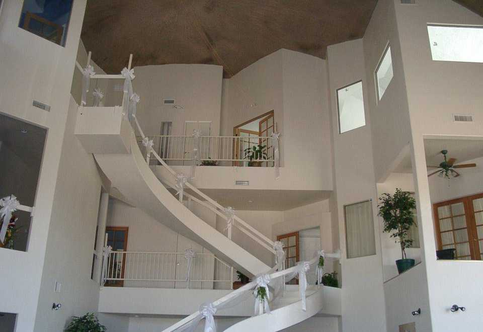 Yuma Dome in Yuma, Arizona  — This staircase leads to the second and third levels in this multigenerational dome that encompasses eight suites, each with at least one bedroom, bathroom, sitting room, laundry area and closets. Dome has 3 stories, 84’ diameter, 40’ inside height, 11,000 square feet of living space.