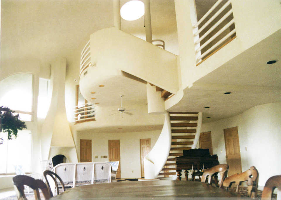 Eye of the Storm on Sullivan Island, South Carolina — A white oak, hand-crafted stairway, following the slope of the interior wall, leads to the third level of this dome, a prolate ellipse, 80′ × 57′ × 34′, with four levels and 3500 square feet of living space.