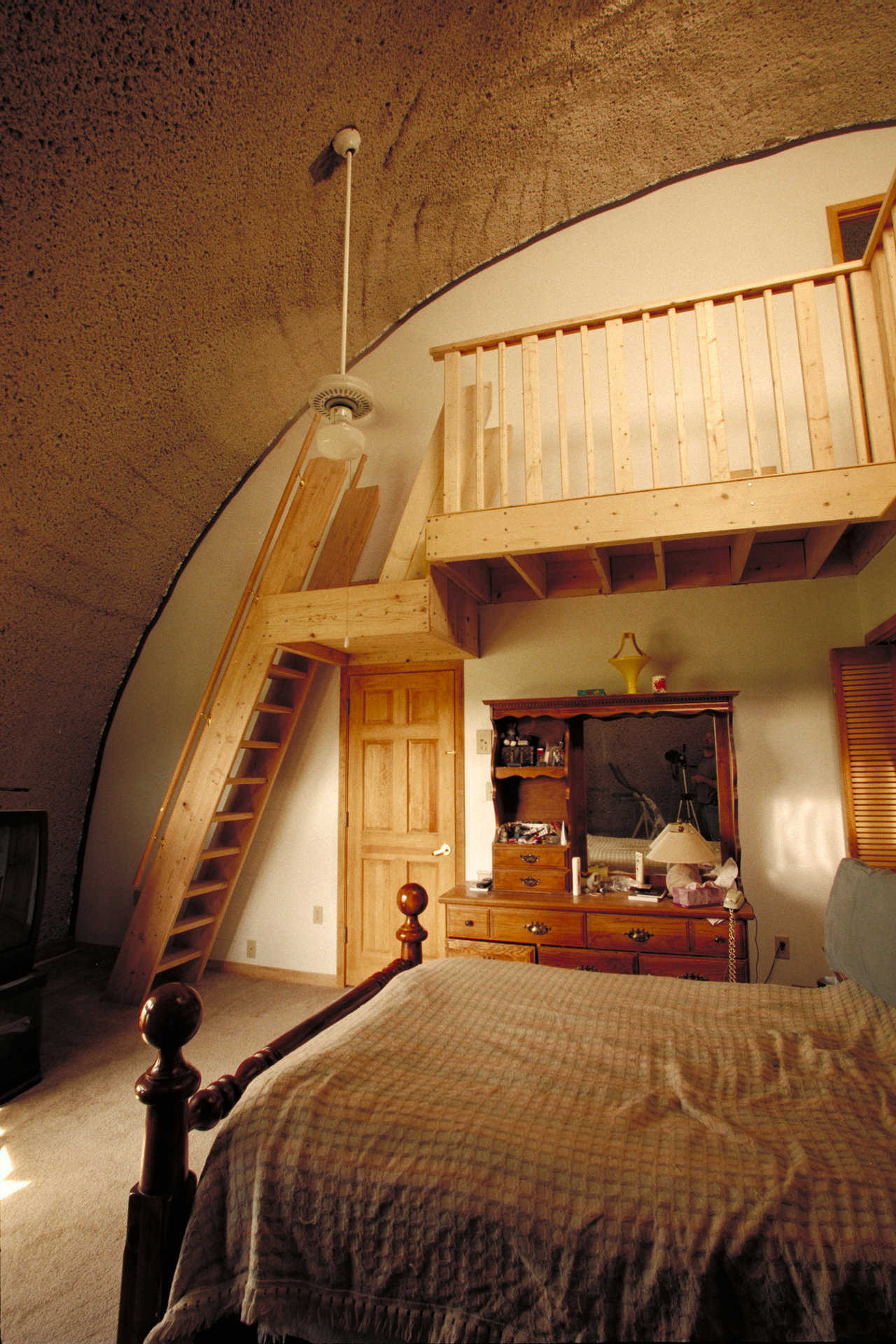 House of Cards in Ann Arbor, Michigan — So nicknamed because its construction was initially financed with credit cards, this Monolithic Dome home sports a wooden “monk” staircase, standing about a foot away from the wall and following its curvature. Made like wooden ladders, monk stairways were first used in monasteries.